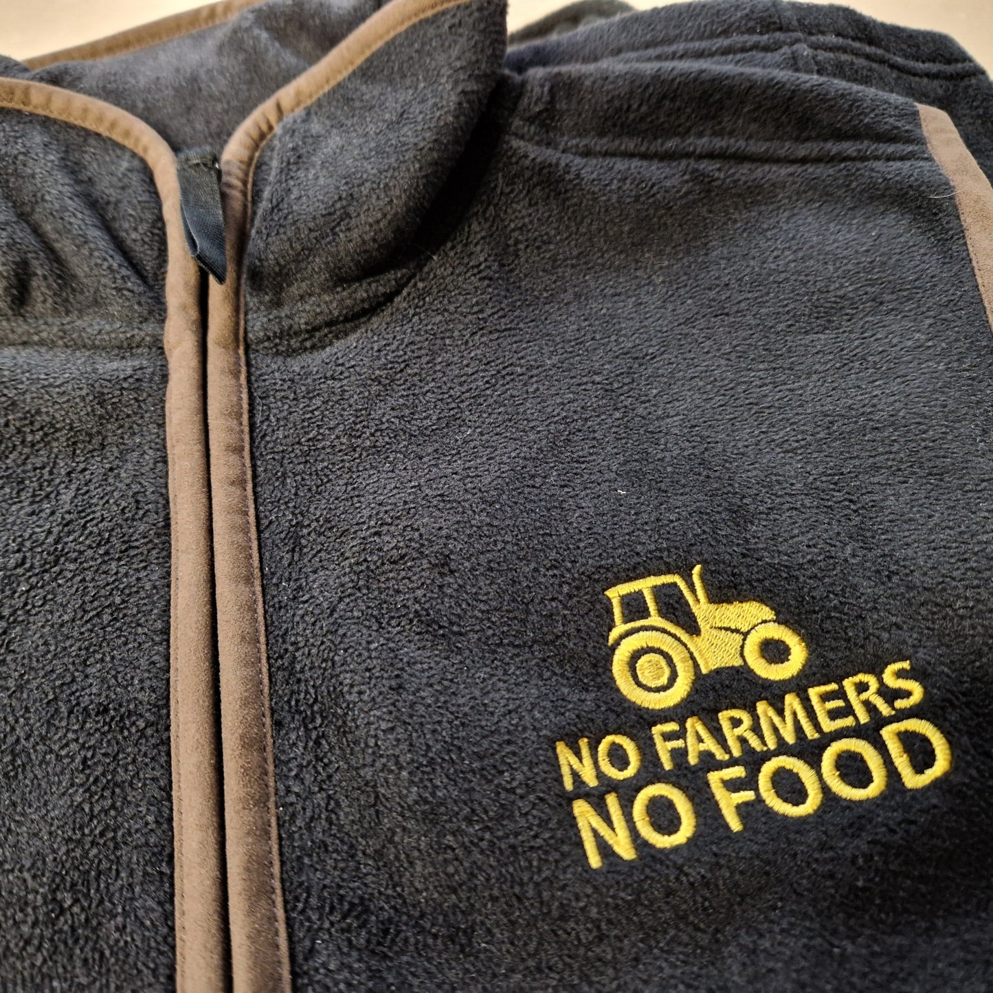 No Farmers No Food yellow embroidered logo on black gilet